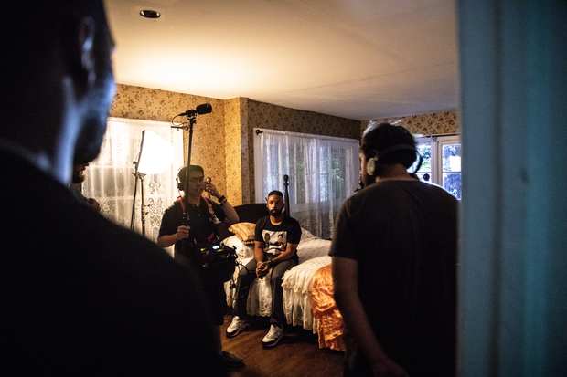 Behind the scenes: lamplight and a full room.