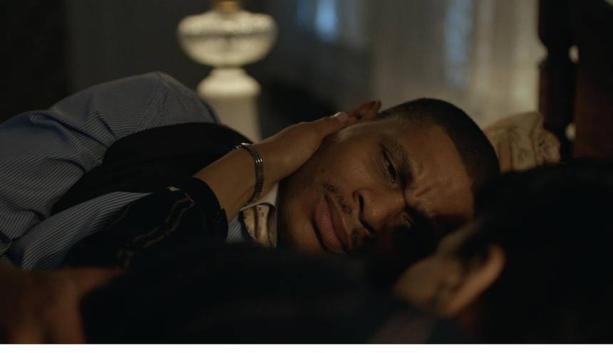 Film frame: Ossian lying awake beside Gladys.