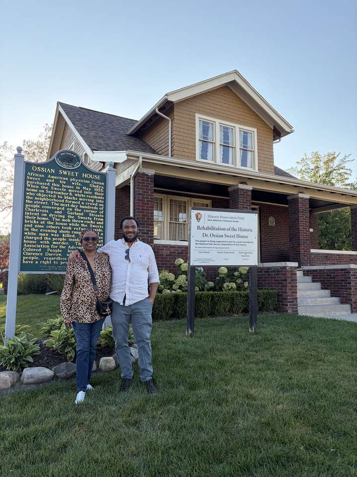 Andrew Colom and his mother outside the Sweet house on Garland.