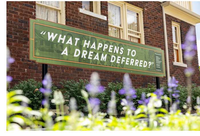 A sign on the brick reading: What happens to a dream deferred?